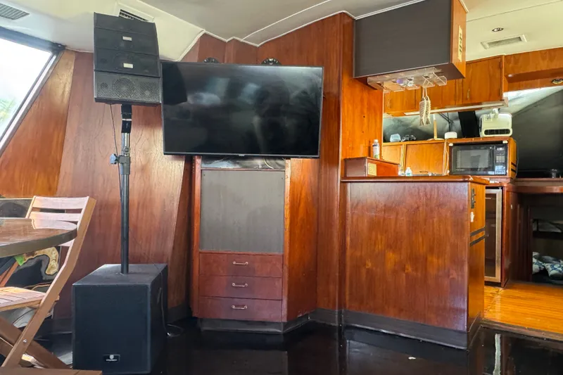 Slide: The Image of Interior of 1989 Ocean Yachts 48 Motor Yacht with TV, speakers, and wooden cabinetry. - 63