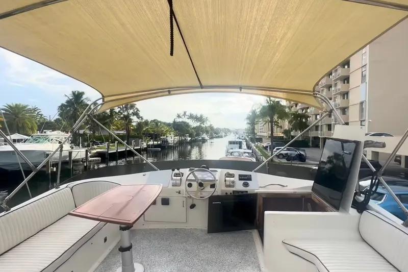 Slide: The Image of 1989 Ocean Yachts 48 Motor Yacht interior with helm, seating, and waterfront view. - 39