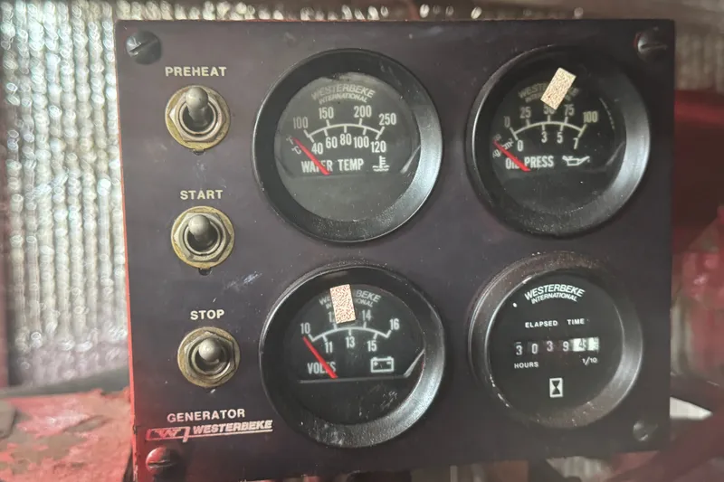 Slide: The Image of Control panel of a 1989 Ocean Yachts 48 Motor Yacht generator with gauges and switches. - 99