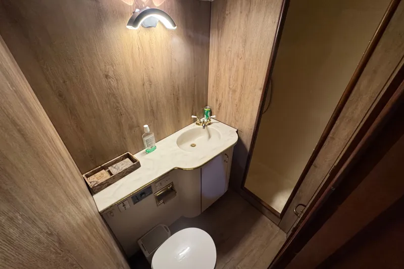Slide: The Image of Bathroom interior of 1989 Ocean Yachts 48 Motor Yacht with wood paneling and modern fixtures. - 93