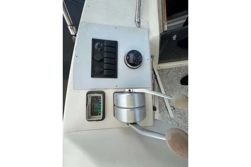 Slide: The Image of Control panel of a 1989 Ocean Yachts 48 Motor Yacht with throttle and gauges. - 103