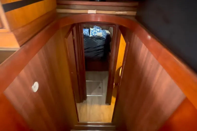 Slide: The Image of Interior view of 1989 Ocean Yachts 48 Motor Yacht, featuring wooden hallway and cozy cabin. - 44