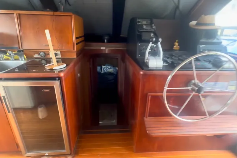 Slide: The Image of 1989 Ocean Yachts 48 Motor Yacht interior with wooden cabinetry and steering wheel. - 43
