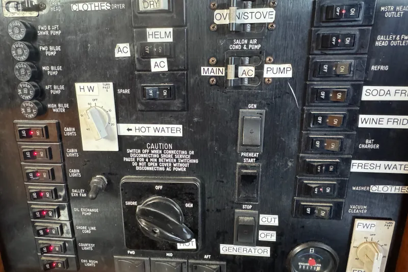 Slide: The Image of Electrical control panel of a 1989 Ocean Yachts 48 Motor Yacht with various switches and labels. - 66