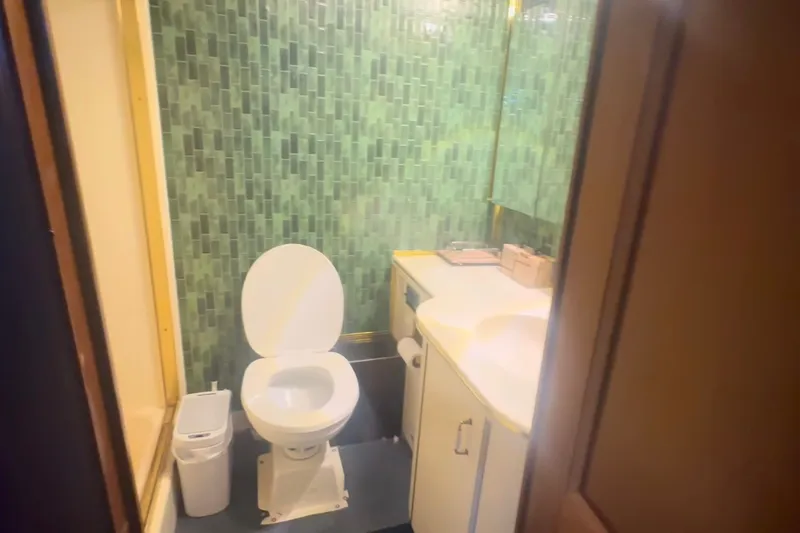 Slide: The Image of Bathroom interior of 1989 Ocean Yachts 48 Motor Yacht with green tiled walls. - 31