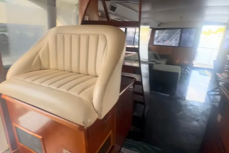 Slide: The Image of 1989 Ocean Yachts 48 Motor Yacht interior with beige seating and spacious lounge area. - 17
