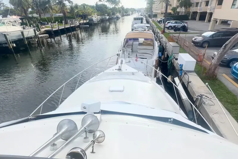 Slide: The Image of 1989 Ocean Yachts 48 Motor Yacht docked in a scenic marina setting. - 36