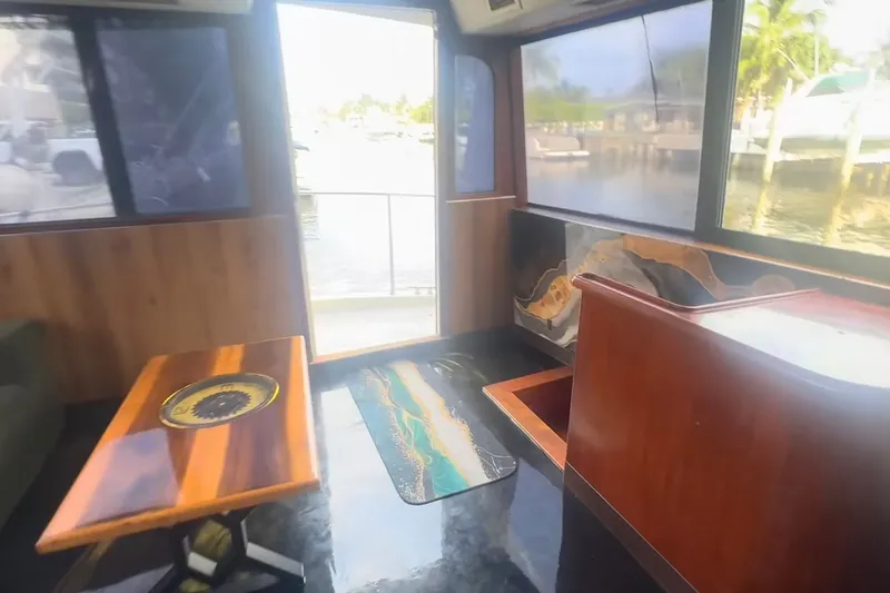 Slide: The Image of Interior of 1989 Ocean Yachts 48 Motor Yacht with wooden table and scenic view. - 24