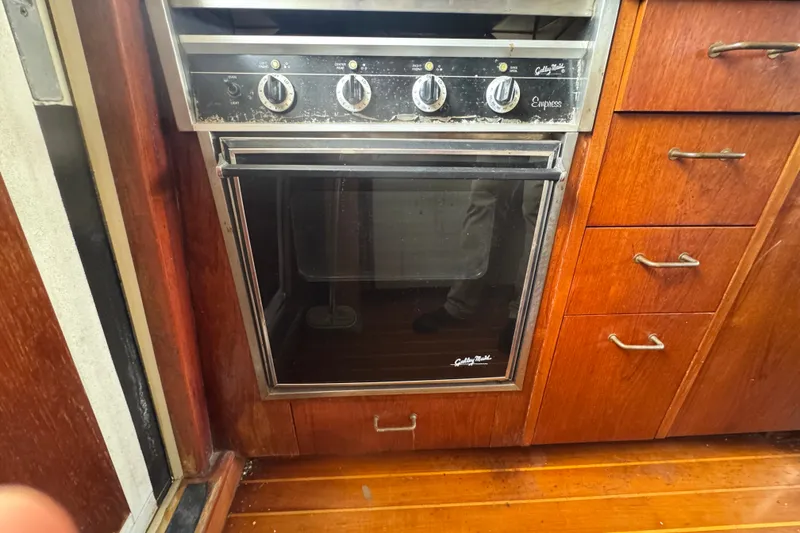 Slide: The Image of Vintage oven in 1989 Ocean Yachts 48 Motor Yacht kitchen, surrounded by wooden cabinetry. - 72