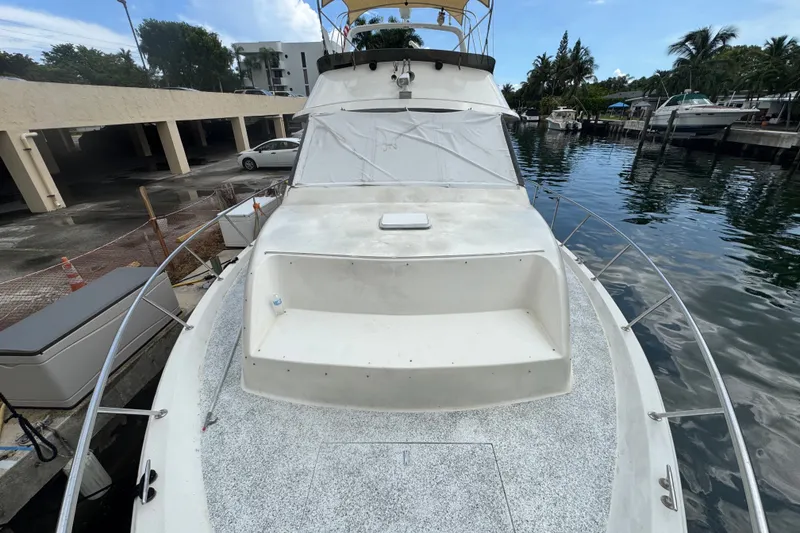 Slide: The Image of 1989 Ocean Yachts 48 Motor Yacht docked, showcasing spacious deck and sleek design. - 115