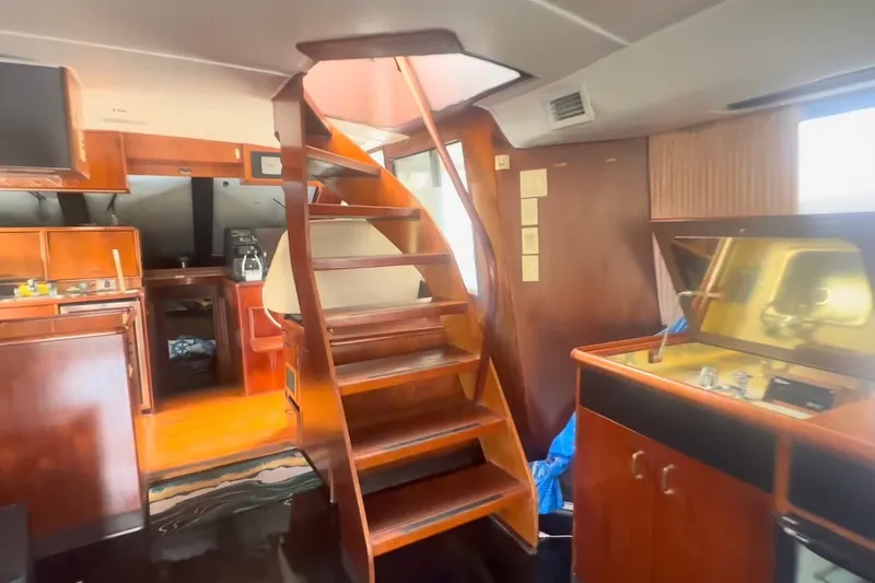 Slide: The Image of Interior of 1989 Ocean Yachts 48 Motor Yacht with wooden staircase and cabinetry. - 34