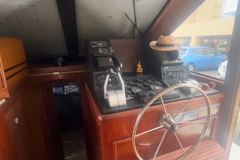 Slide: The Image of 1989 Ocean Yachts 48 Motor Yacht helm with steering wheel and control panel. - 16