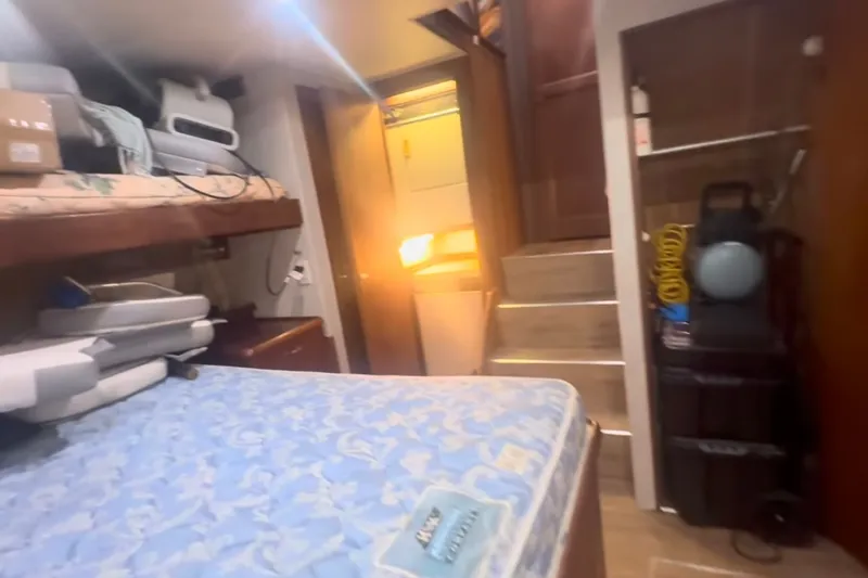 Slide: The Image of Interior of 1989 Ocean Yachts 48 Motor Yacht with bed and storage area. - 51