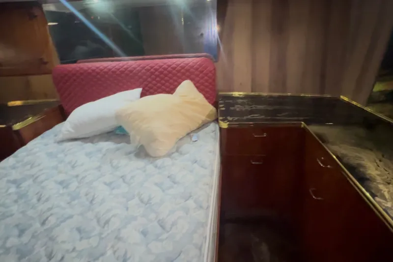 Slide: The Image of Interior cabin of 1989 Ocean Yachts 48 Motor Yacht with bed and wooden cabinetry. - 29