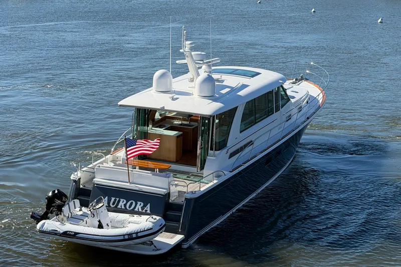 Slide: The Image of 2020 Sabre 58 Salon Express yacht cruising on a scenic river with surrounding boats. - 44