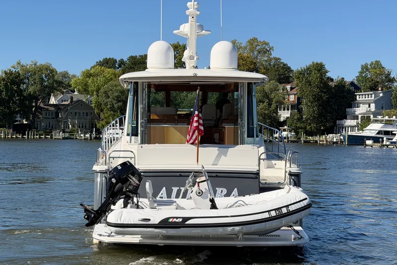 Slide: The Image of Sabre 58 Salon Express 2020 yacht on a scenic river with waterfront homes. - 46