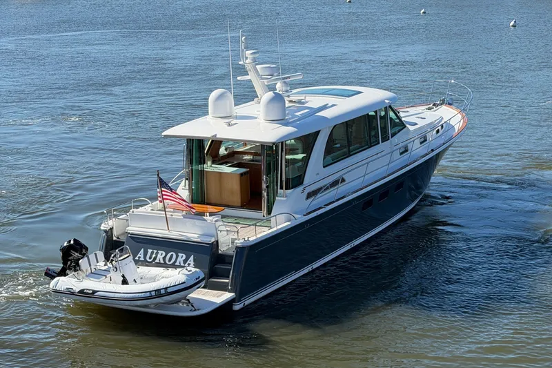 Slide: The Image of 2020 Sabre 58 Salon Express yacht cruising on a serene waterway. - 1