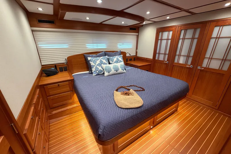 Slide: The Image of Luxurious 2020 Sabre 58 Salon Express bedroom with elegant wood finishes and cozy bedding. - 23