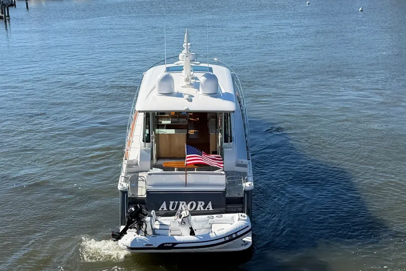 Slide: The Image of 2020 Sabre 58 Salon Express yacht cruising in a marina with American flag. - 43