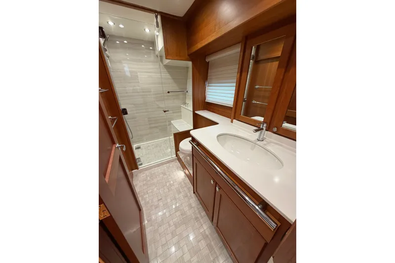 Slide: The Image of Luxurious bathroom in 2020 Sabre 58 Salon Express yacht with modern fixtures and wood accents. - 25