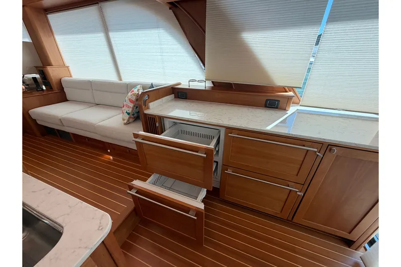 Slide: The Image of Luxurious interior of 2020 Sabre 58 Salon Express yacht with wooden cabinetry and plush seating. - 7