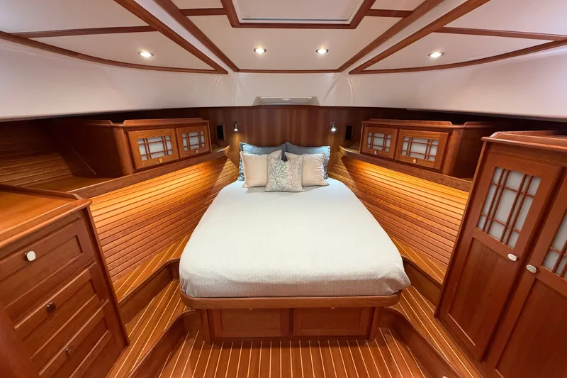 Slide: The Image of Luxurious 2020 Sabre 58 Salon Express cabin with elegant wood finish and cozy bedding. - 27