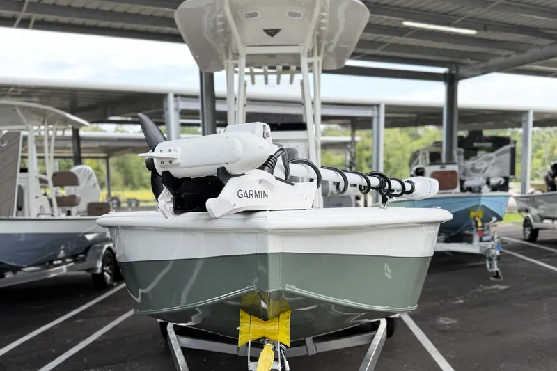 Slide: The Image of Front view of 2027 Avid 23 Mag boat with Garmin equipment in a covered marina. - 3