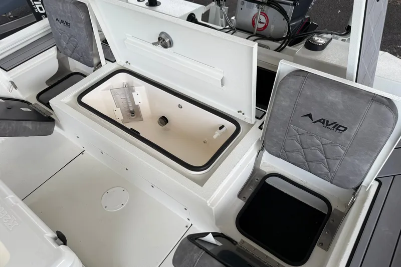 Slide: The Image of Avid 23 Mag 2027 boat interior with storage compartments and seating. - 19