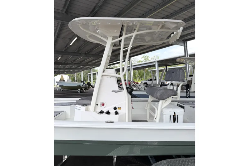 Slide: The Image of Avid 23 Mag 2027 boat with T-top and seating under covered storage. - 6