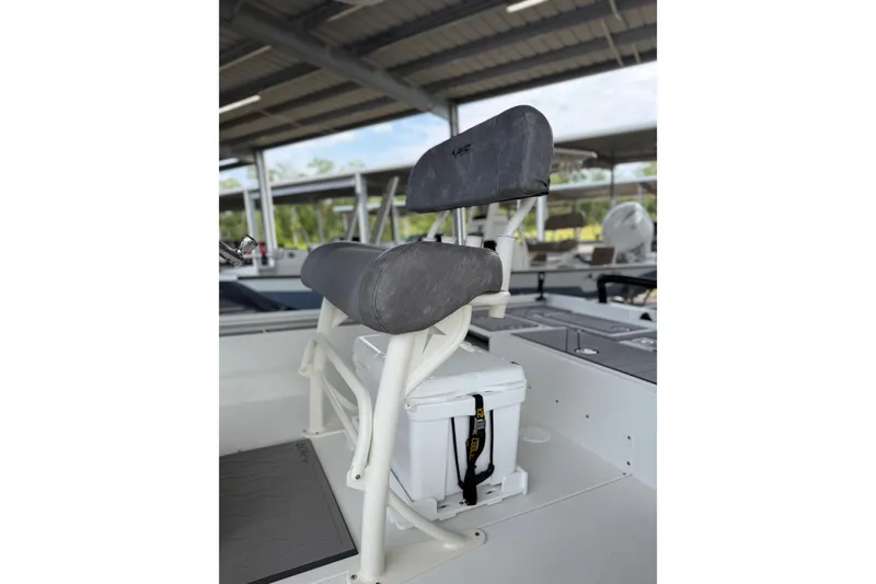 Slide: The Image of Avid 23 Mag 2027 boat seat with cooler underneath in a covered marina. - 9
