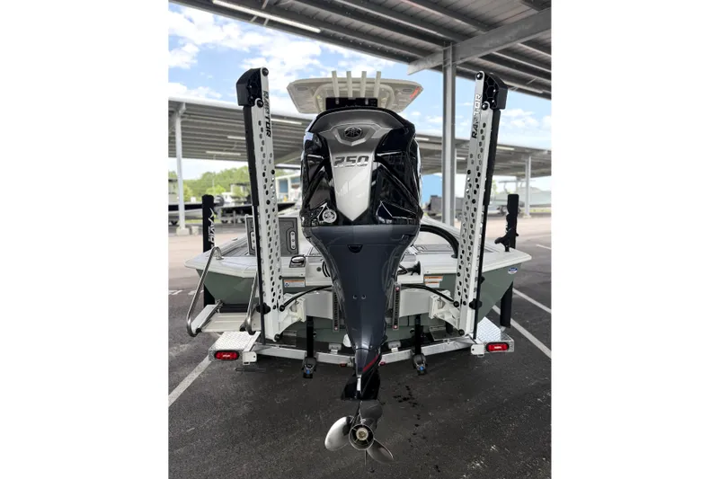 Slide: The Image of Avid 23 Mag 2027 boat with powerful outboard motor in a covered marina. - 16