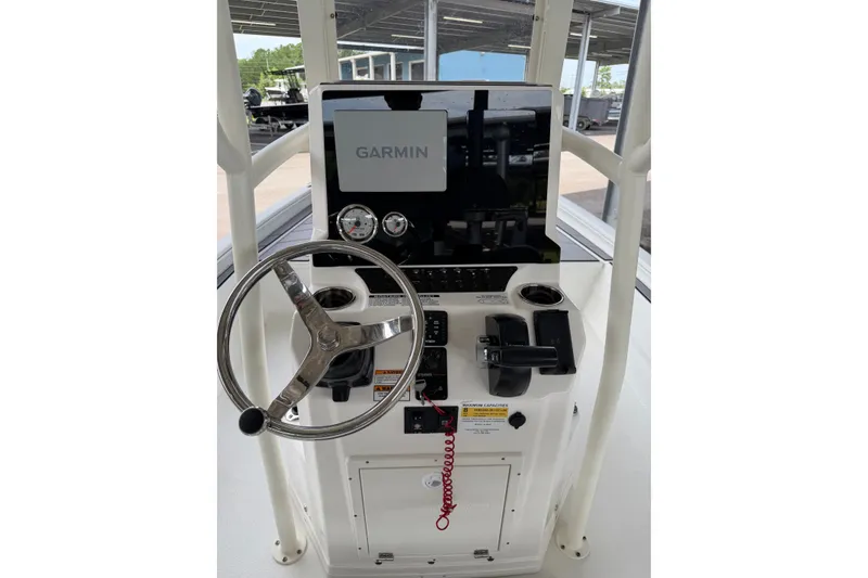 Slide: The Image of Boat console with Garmin display, steering wheel, and controls on Avid 23 Mag, 2027 model. - 20