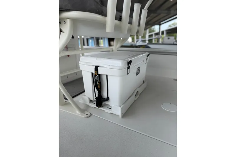 Slide: The Image of White cooler secured on Avid 23 Mag boat, 2027 model, with rod holders above. - 8