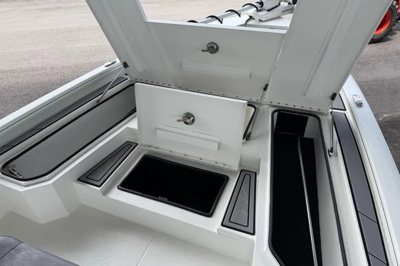 Slide: The Image of Open storage compartments on a 2027 Avid 23 Mag boat deck. - 23