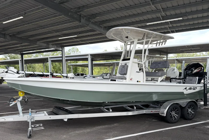 Slide: The Image of Avid 23 Mag 2027 boat on trailer under covered parking. - 2