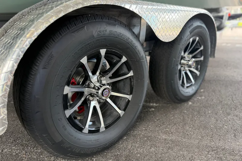 Slide: The Image of Close-up of Avid 23 Mag 2027 model wheels with chrome rims and diamond plate fender. - 12