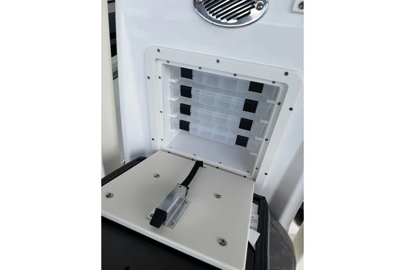 Slide: The Image of Open storage compartment on Avid 23 Mag 2027 boat, featuring organized shelves and secure latch. - 21