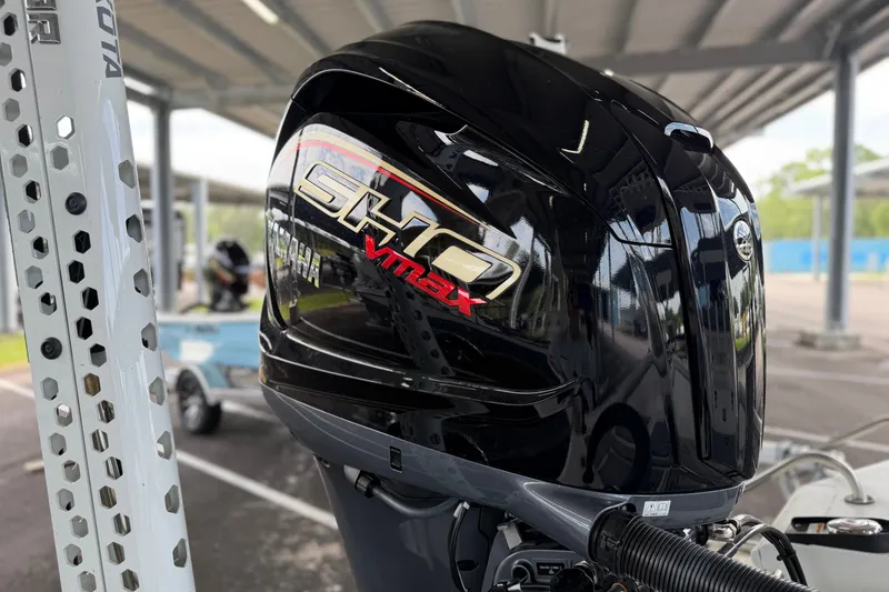 Slide: The Image of 2027 Avid 23 Mag with Yamaha SHO VMAX outboard motor under a covered area. - 15