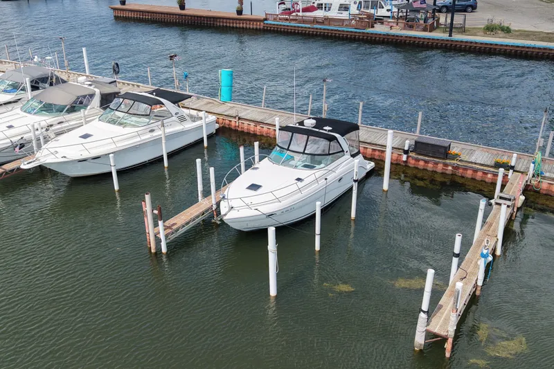 The Image of 2008 Rinker 320 Express Cruiser docked at marina, aerial view. - 1