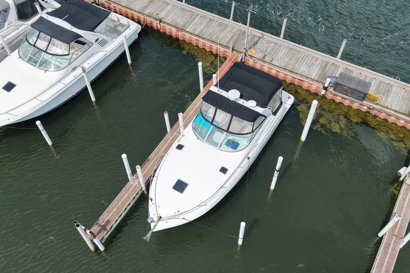 Slide: The Image of 2008 Rinker 320 Express Cruiser docked at marina, aerial view. - 2