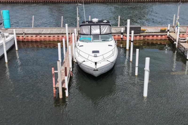 Slide: The Image of 2008 Rinker 320 Express Cruiser docked at marina, front view. - 7