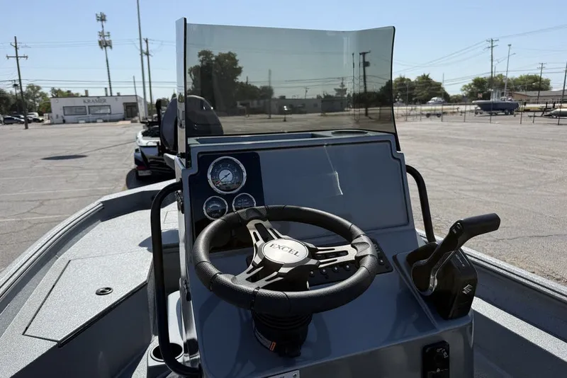 Slide: The Image of 2027 Excel 203 Bay Pro Elite boat dashboard with steering wheel and controls. - 14