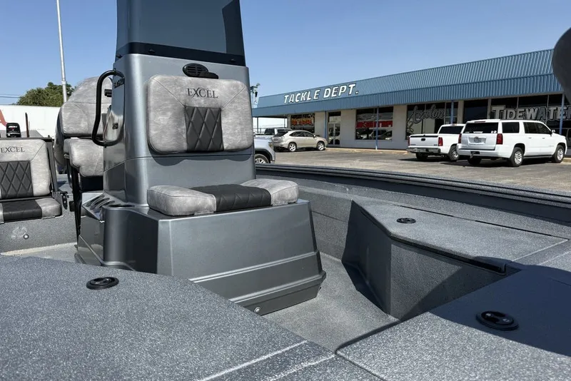 Slide: The Image of 2027 Excel 203 Bay Pro Elite boat interior at dealership, featuring gray seating and console. - 17