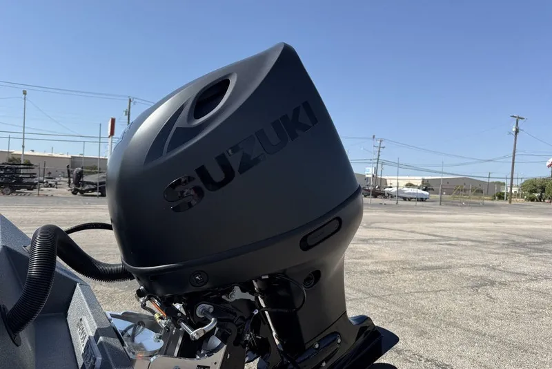 Slide: The Image of Suzuki outboard motor on 2027 Excel 203 Bay Pro Elite boat, parked outdoors. - 13