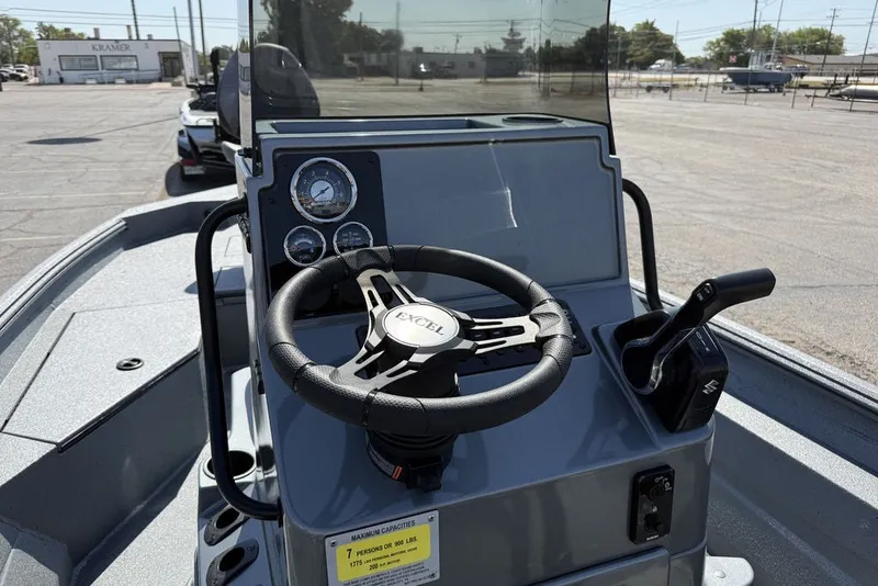 Slide: The Image of Steering console of 2027 Excel 203 Bay Pro Elite boat, featuring gauges and controls. - 16