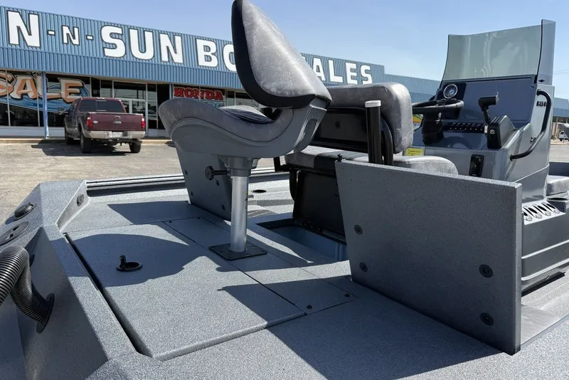 Slide: The Image of 2027 Excel 203 Bay Pro Elite boat interior at dealership, showcasing seating and console. - 15