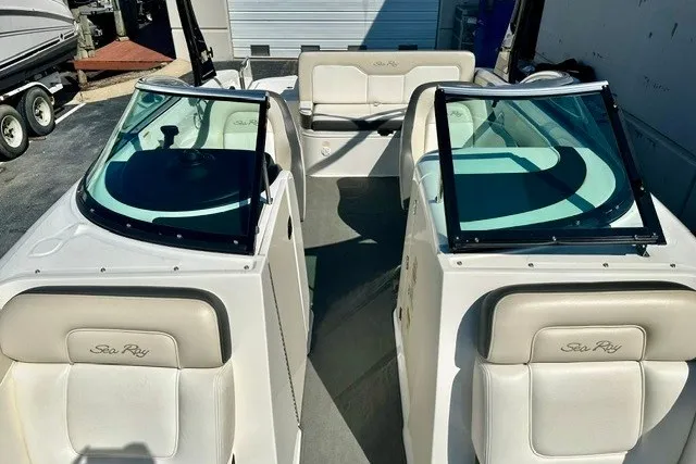 Slide: The Image of 2013 Sea Ray 240 Sundeck boat interior with seating and windshields. - 17