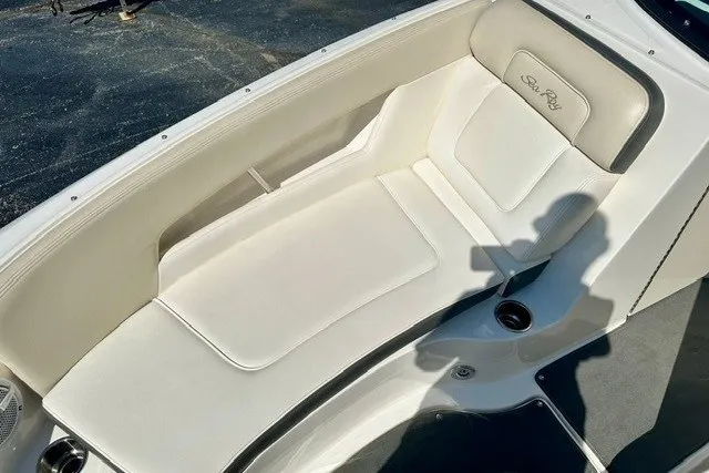 Slide: The Image of 2013 Sea Ray 240 Sundeck boat interior with white cushioned seating. - 14