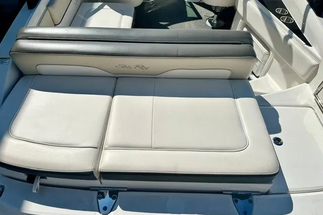 Slide: The Image of 2013 Sea Ray 240 Sundeck boat interior with white cushioned seating. - 16