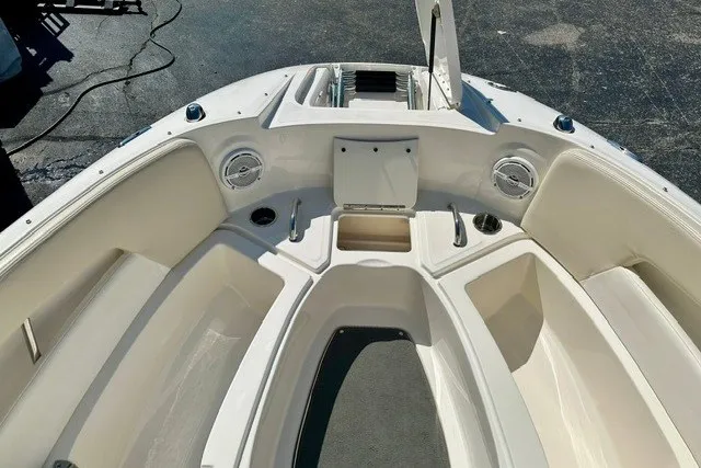 Slide: The Image of 2013 Sea Ray 240 Sundeck boat interior with seating and storage compartments. - 22